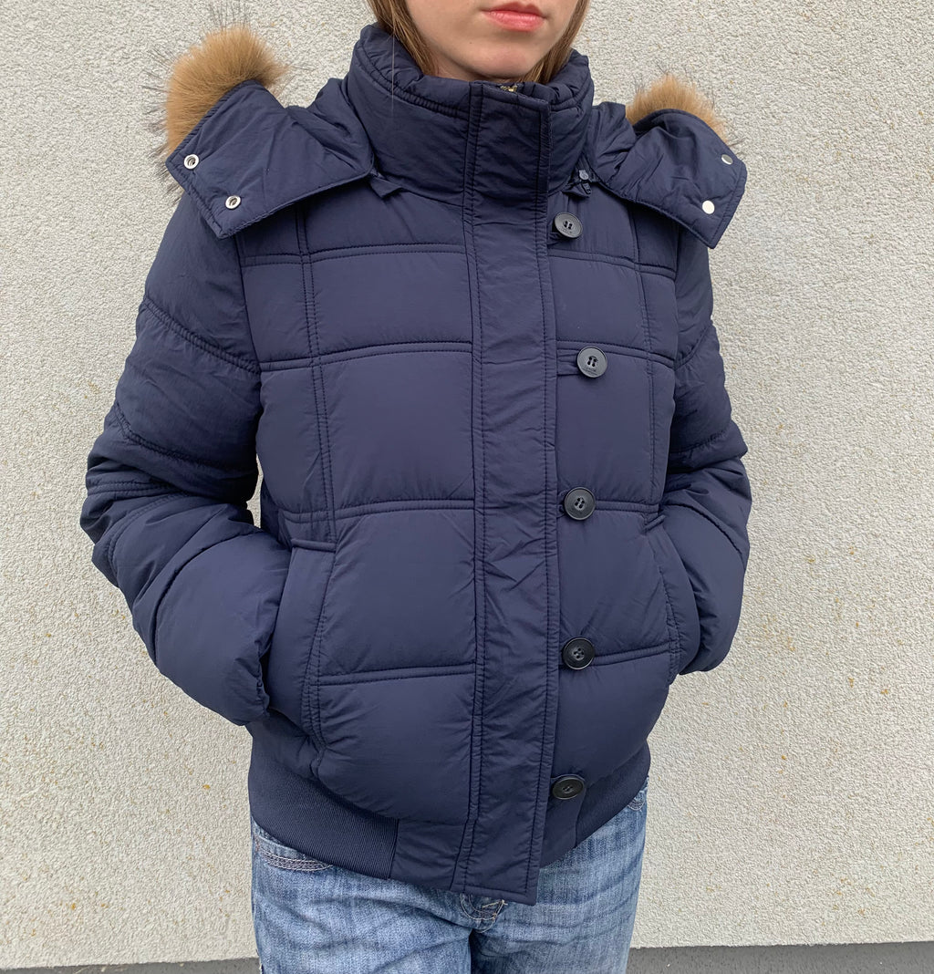 Down winter jacket with a hood trimmed with faux fur