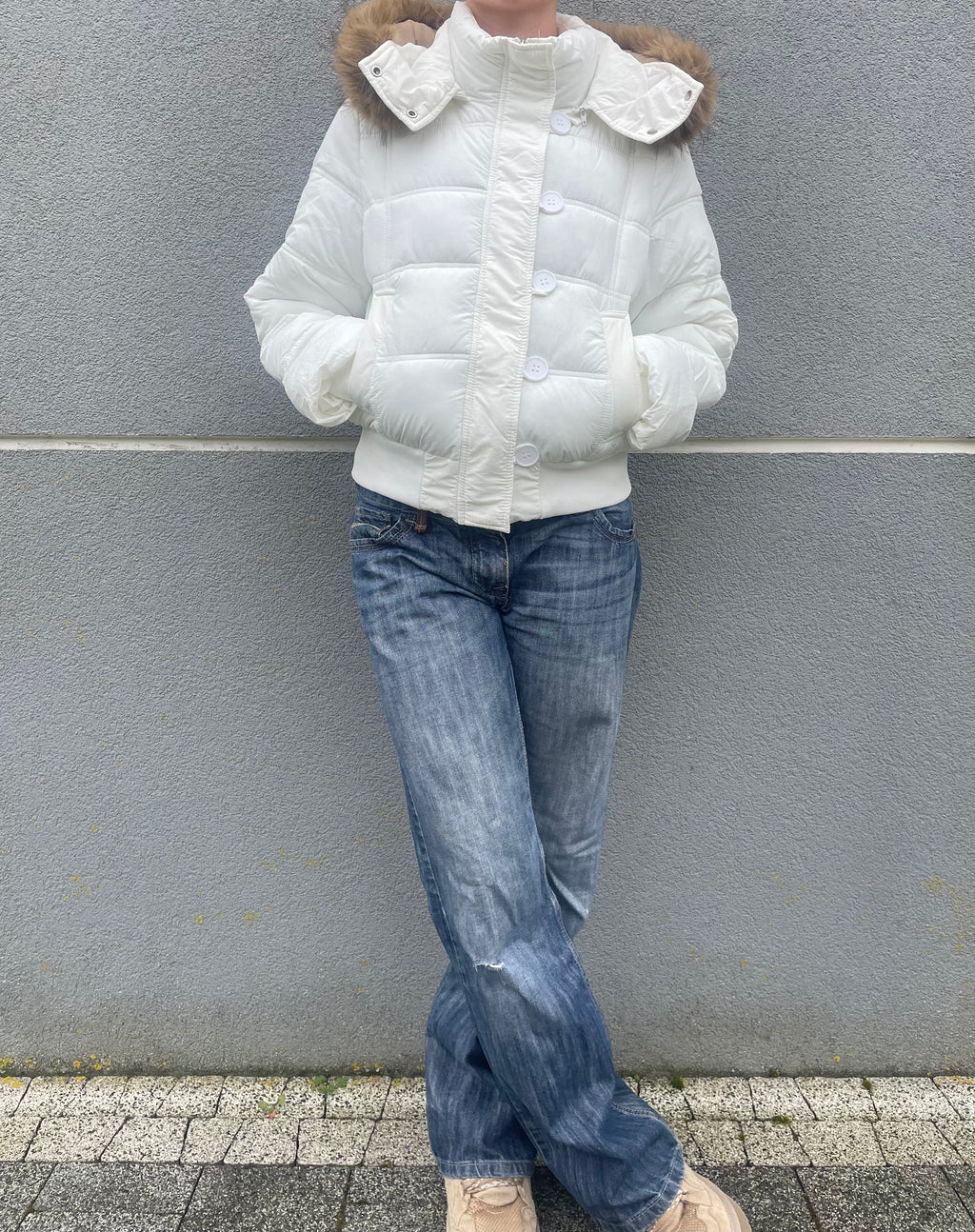 Down winter jacket with a hood trimmed with faux fur